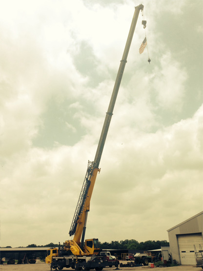 Marine Corp veteran and Luckett Crane Service employee hang American flag from Grove 900E 90 ton hydraulic truck crane to celebrate Independence Day